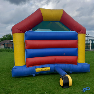 Inflatable bounce house featuring a red and blue color scheme with a yellow base.