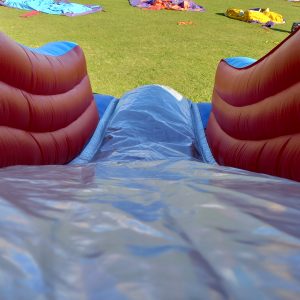 View of an inflatable circus slide showing the slide surface and side walls.