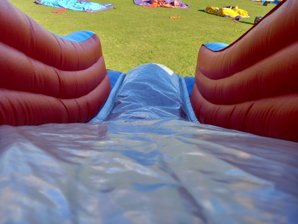 View of an inflatable circus slide showing the slide surface and side walls.