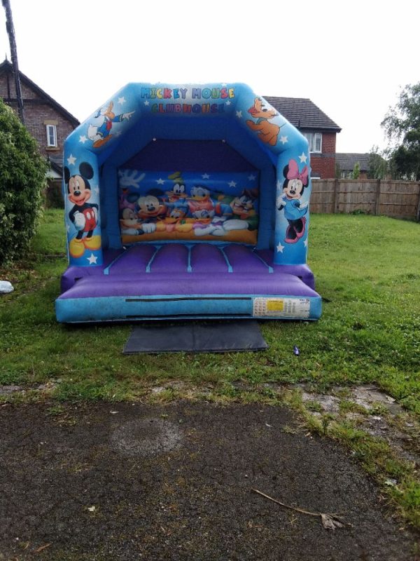 Mickey Mouse themed inflatable bounce house featuring characters from Disney.