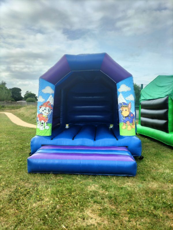 Paw Patrol themed inflatable bounce house with characters on the sides and a blue structure.