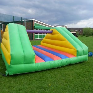 Inflatable Pillow Bash game with colorful sections and a central padded area for play.