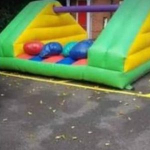 Inflatable Pillow Bash game featuring colorful padded areas and soft pillows in red, blue, and green.