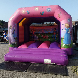 Inflatable bounce house featuring princess-themed graphics and colorful designs.