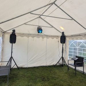 Interior view of a gazebo featuring two speakers and a light fixture mounted on the ceiling.